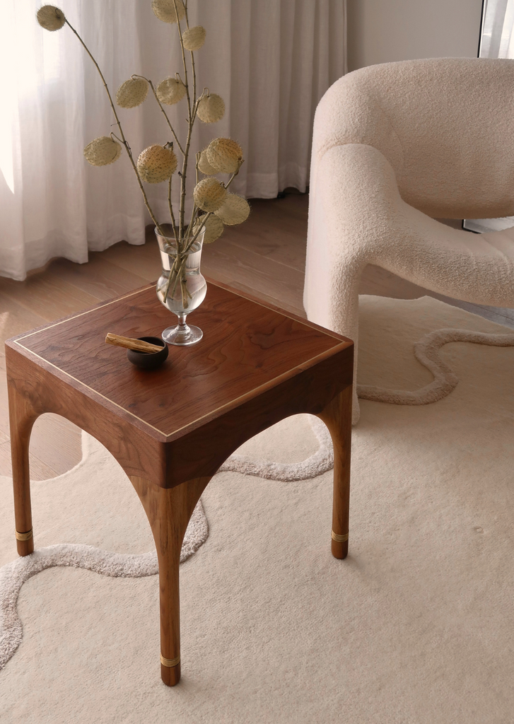 Wela Side Table Baan Collection – sculptural side table embodying fluidity in walnut