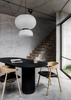 Underline Table – sculptural dining table in Black Oak with hollow cylindrical bases